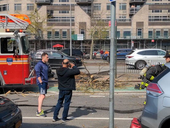 The fence dividing queens blvd and its access road, smashed by an SUV. Fire trucks are here.