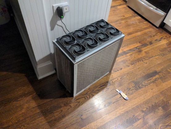 A PC fan CR box. It has 8 black (arctic P12) PC fans on top, a 20x20 filter on one side, and a 10x20 filter on the other side.

There's also a random cat toy on the floor (a fish).
