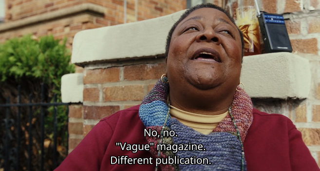 The Black woman is responding to Charlie Cale, saying "No, no. 'Vague' magazine. Different publication."